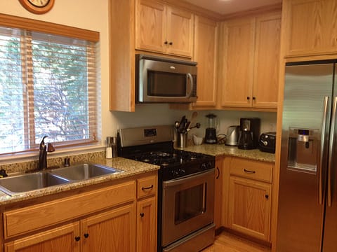 Fully equipped kitchen with granite countertops and stainless steel appliances.