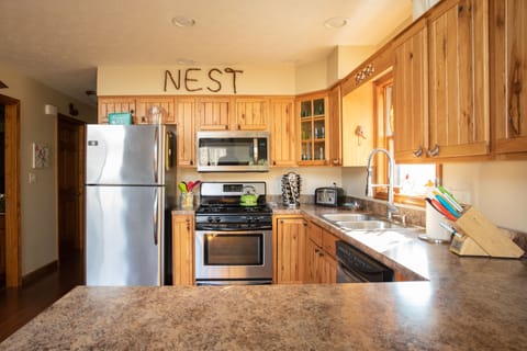 Kitchen with plenty of prep room. gas stove, micro wave, dishwasher and fridge.