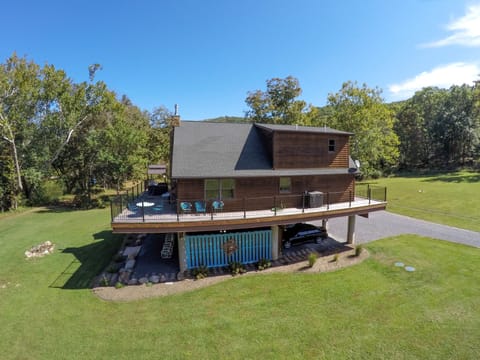 Side view of house with protected parking for 2 cars.
