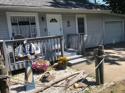 Entrance from parking area; small deck with grill right outside of the kitchen.