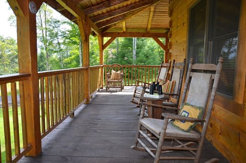 The deck. Three rockers, several chairs, picnic table and gas grill.