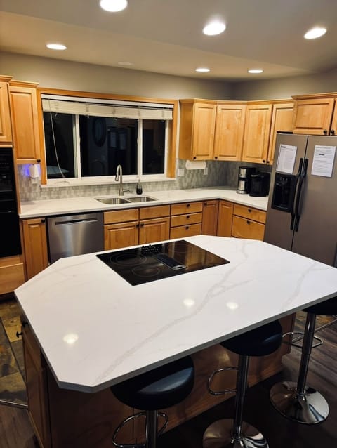 Kitchen is remodeled with new countertops and backsplash
