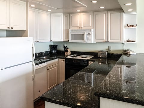 fully equipped kitchen clean white cabinets new appliances granite counters