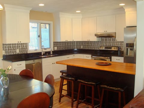 Modern bright kitchen.  Breakfast bar seats 4. Dining table seats 6.  