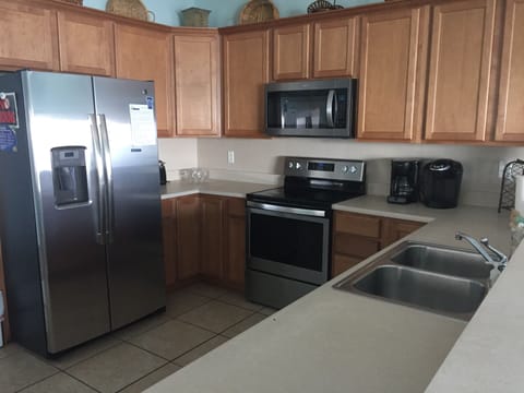 Fully stocked kitchen with stainless appliances