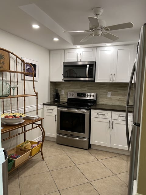 Shelf with bins, range and microwave