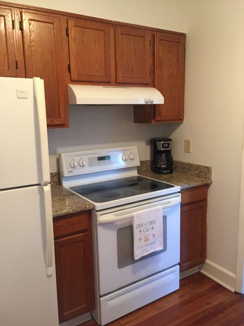 Galley kitchen stocked with all required cookware, dishes and appliances.