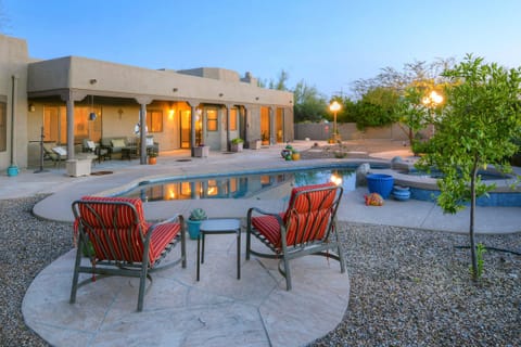 Evening view of backyard pool and hot tub. 