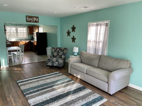 This apartment living room has brand new wood flooring (2022) & a sleeper sofa. 