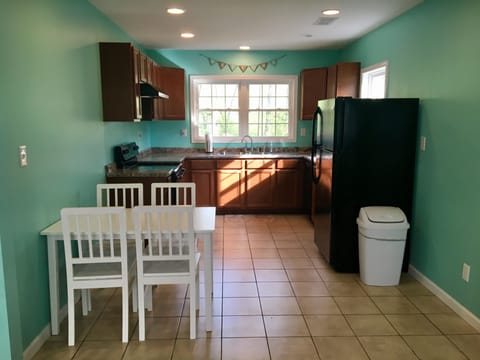 The apartment kitchen is fully stocked for eating & cooking.