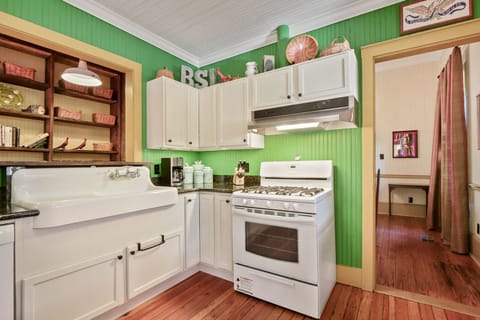 Updated kitchen with gas stove and view of the dining room. 