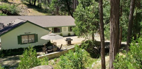 Outdoor seating and BBQ next to the creek.