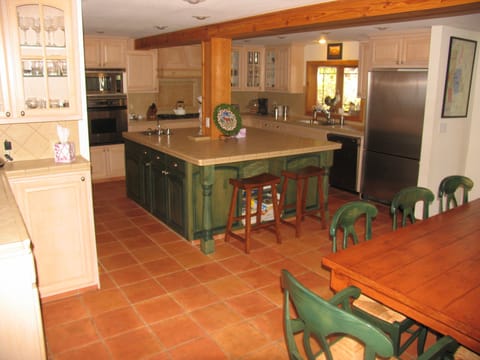Large kitchen and dining area. Two dishwashers, prep sink, trash compactor