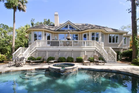 Rear of the home.  Poolside seating areas and back deck. Pool and Spa  