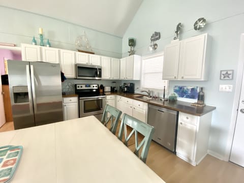 Custom wood countertops, stainless appliances and fully stocked kitchen