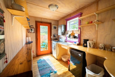 Fully stocked kitchen: range, microwave, toaster, kettle, coffee makers, spices