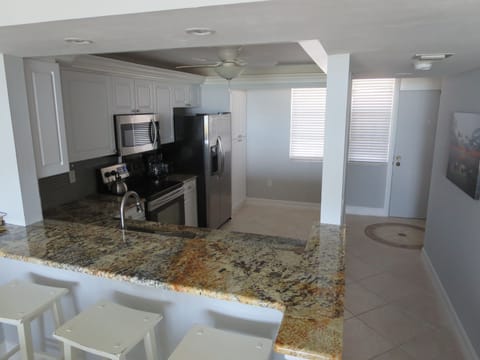 3 bar stools and New granite counters  extends Kitchen to Dining area.