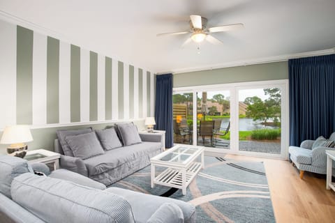 Living room with lake view and private patio