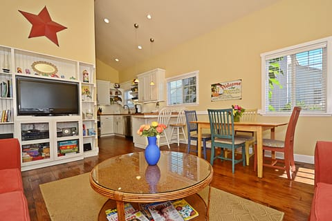 Great room with dining table and entertainment center.