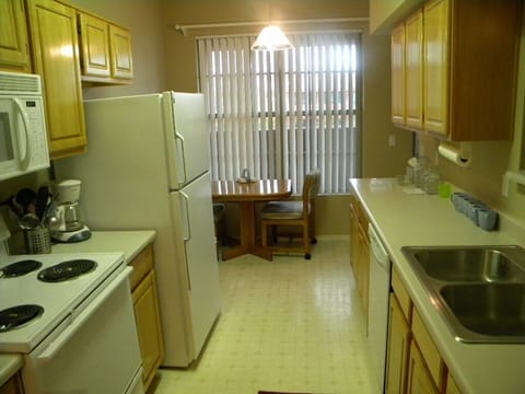 Well stocked galley kitchen with dining area