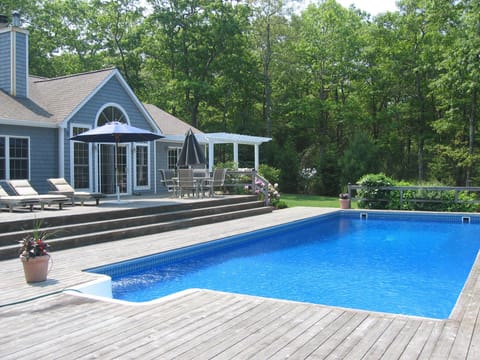 Oversized heated pool with large deck, hot tub and outdoor shower