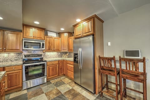 Fully Equipped Chef's Kitchen with Granite Slab, Slate Floors, and Breakfast Bar