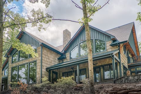 Beautiful custom home with grand windows and Poplar bark siding 