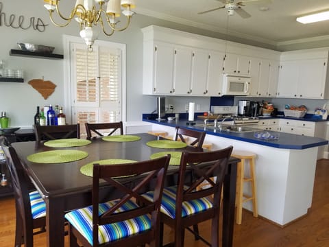Counter Height Table with 6 Chairs, 4 bar stools along the kitchen island