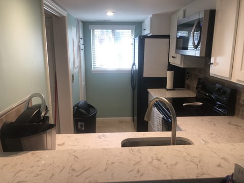 Standing in the dining room looking into the kitchen