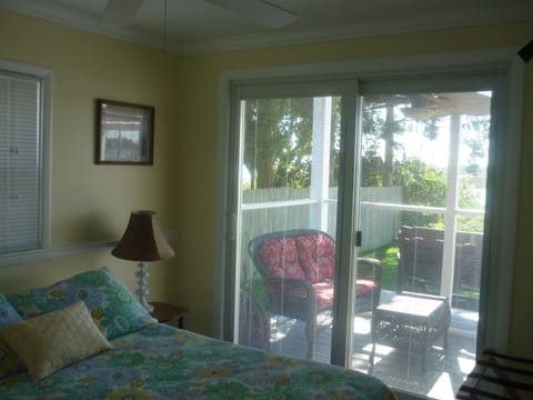 1st floor bedroom with full size bed and doors leading to deck 