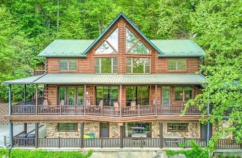 Log cabin perched on a peaceful mountain ridge with views of the river below