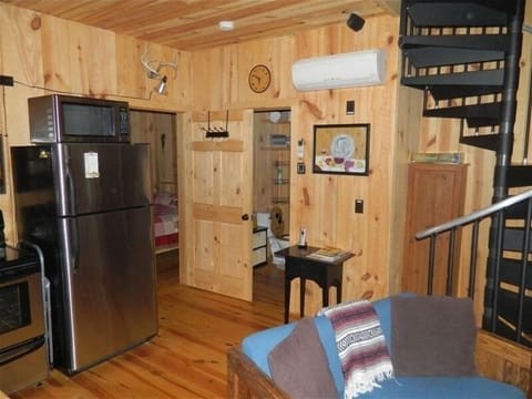 part of kitchen, looking into bathroom and bedroom, dart board behind the door