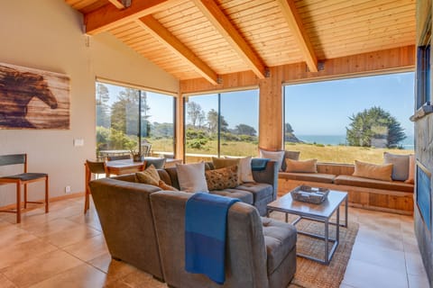 The great room with panoramic views to the meadows and sea