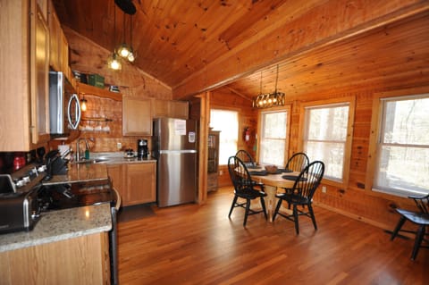 Fully equipped kitchen with dining area .