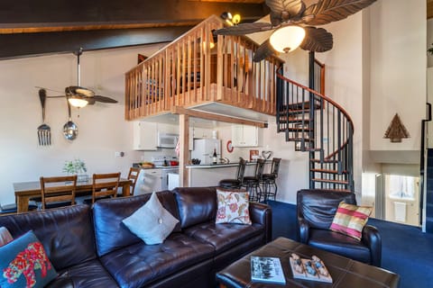 Living area with view of game room and kitchen