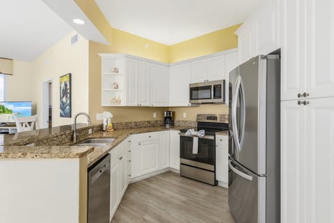Kitchen equipped with quiet, stainless steel dishwasher.