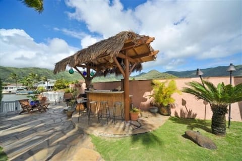 Island style Tiki Bar with fire pit at waters edge