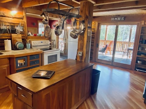 Kitchen with dining access and patio door access to large deck