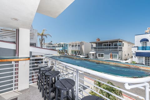 Middle level front balcony - one of three total balconies - with ocean view, cafe' seating and propane BBQ grill. Accessed from living room.
                