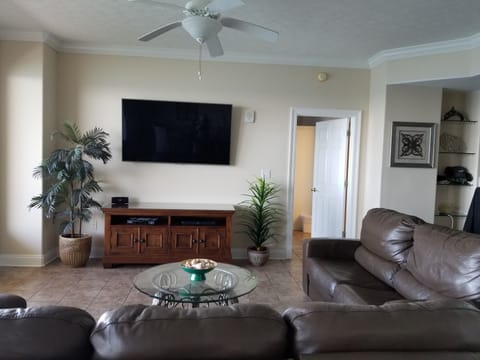 65" TELEVISION, LEATHER FURNITURE, TILE FLOORS