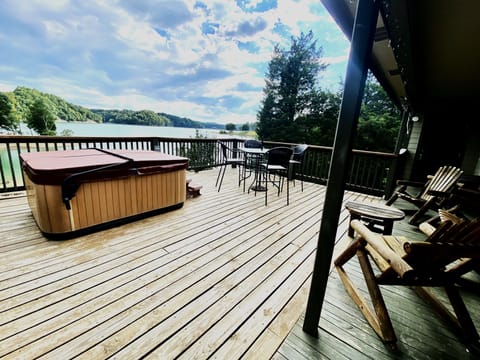 Large Deck with hot tub and sloping yard to water