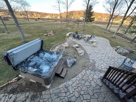 HUGE Patio, Hot Tub, firepit, bar area, large level backyard, docks, and more...