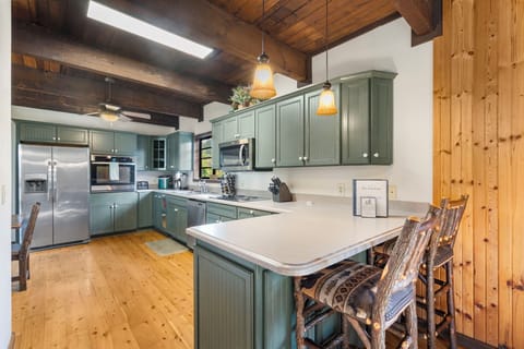 Spacious kitchen with stainless appliances and seating for 2