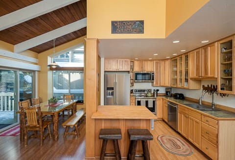 Bar/prep counter next to open kitchen and dining area.