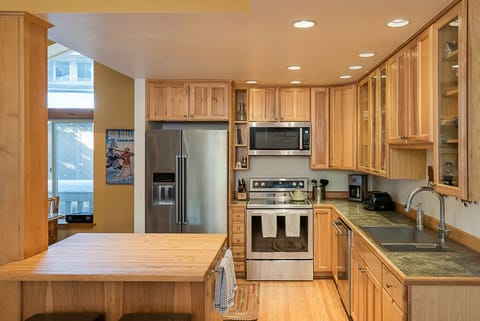 Open gourmet kitchen, newer appliances and cabinets stocked with what you need.