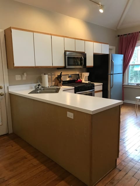 Large, vaulted ceiling kitchen with skylight and plenty of windows.