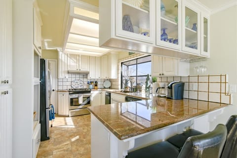 Spacious open kitchen with stainless steel appliances includes a dishwasher.