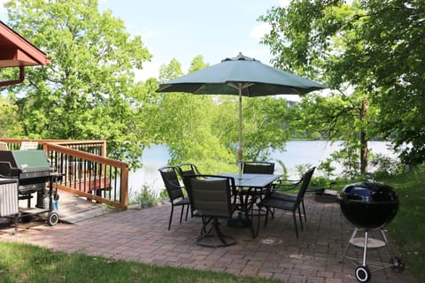Patio with outdoor dining area and grill