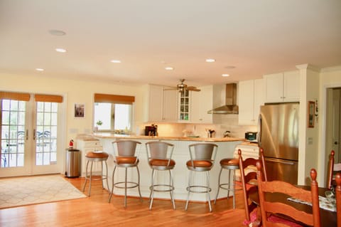 Chef's kitchen has an  island bar with seating for 5, next to dining room/LR.