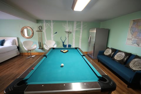 Pool table, ping pong table, TV, and refrigerator.